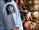 A police officer holds a cannabis pipe confiscated at the rally